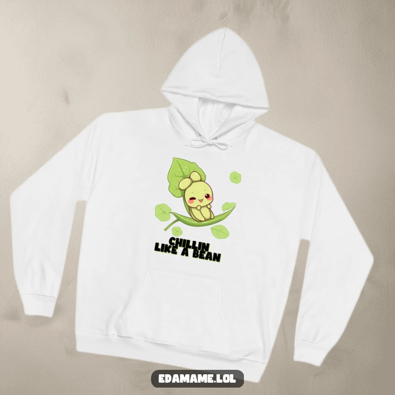 Funny hoodie depicting a cute edamame character gleefully sliding down a leaf, perfect for cozying up with a smile.