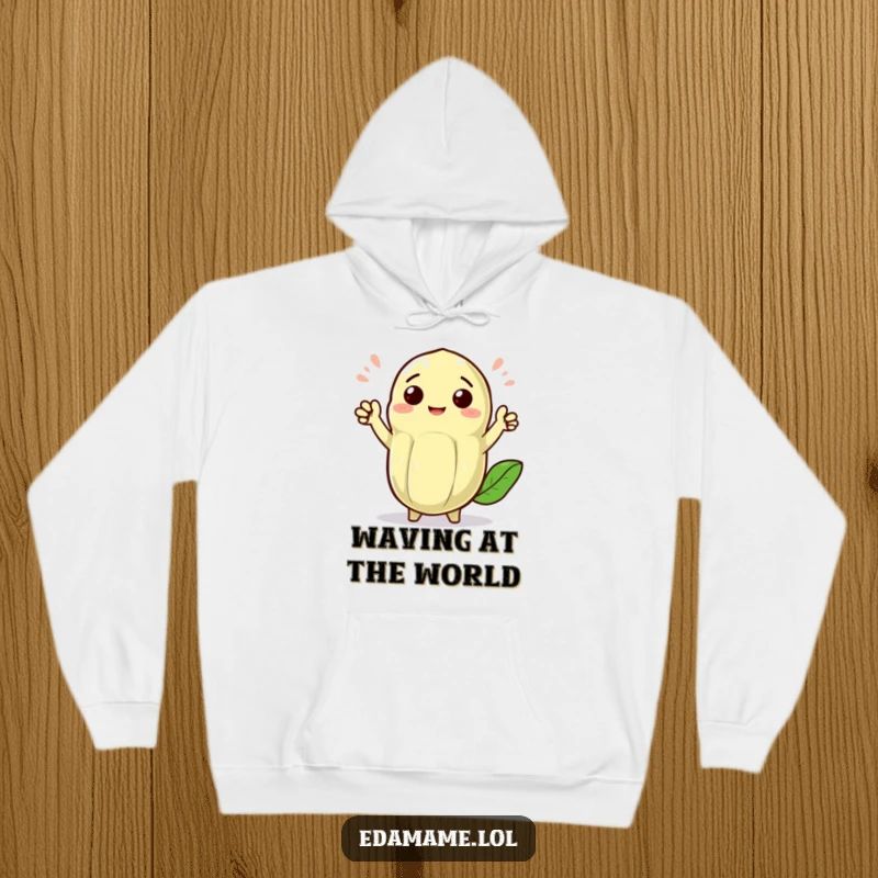 Funny cheerful edamame pod with tiny arms waving enthusiastically, featured on a cozy hoodie, spreading warmth and greetings.